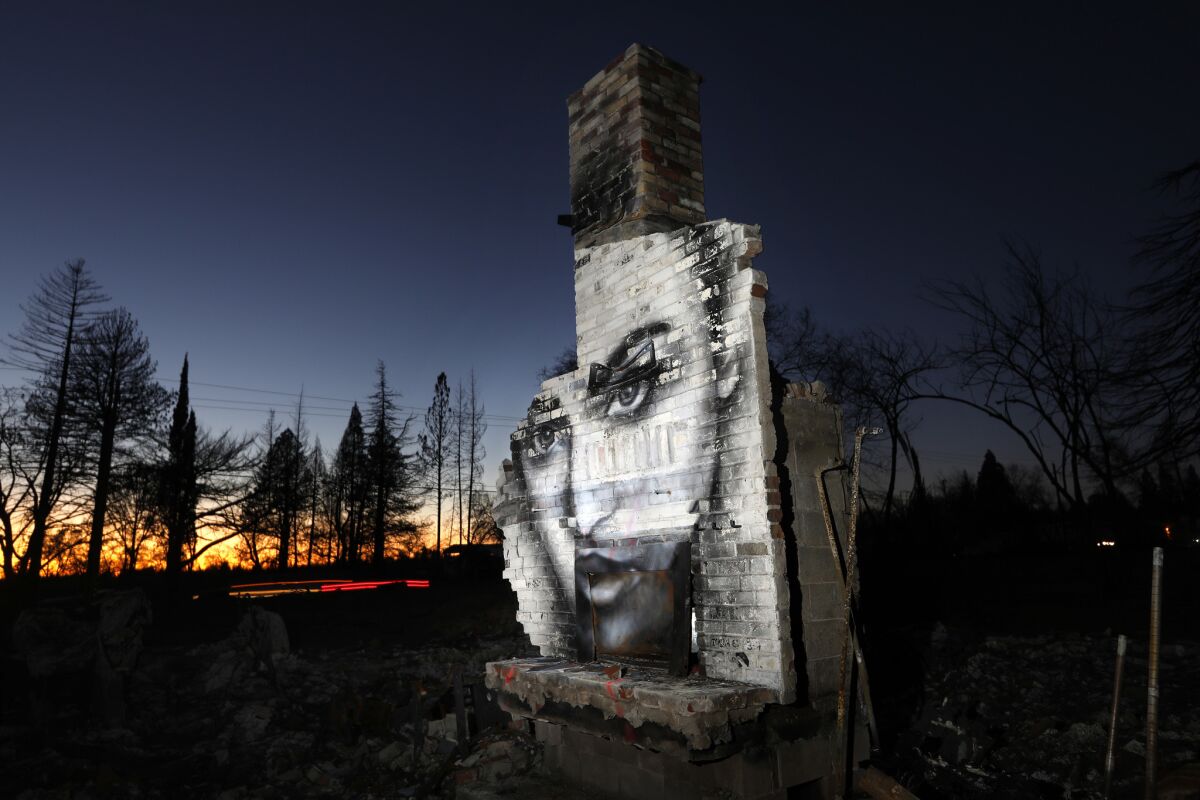PARADISE, CALIFORNIA--FEB. 23, 2019--"Beauty Amongst The Ashes," no longer exists as the building was demolished. Artist and muralist Shane Grammer, originally of Chico, CA, had been painting images of inspiration around the world, and has now taken on Paradise, CA, as his canvas. He works in the theme park industry as a freelance artist and now lives in the Greater LA area. (Carolyn Cole/Los Angeles Times)