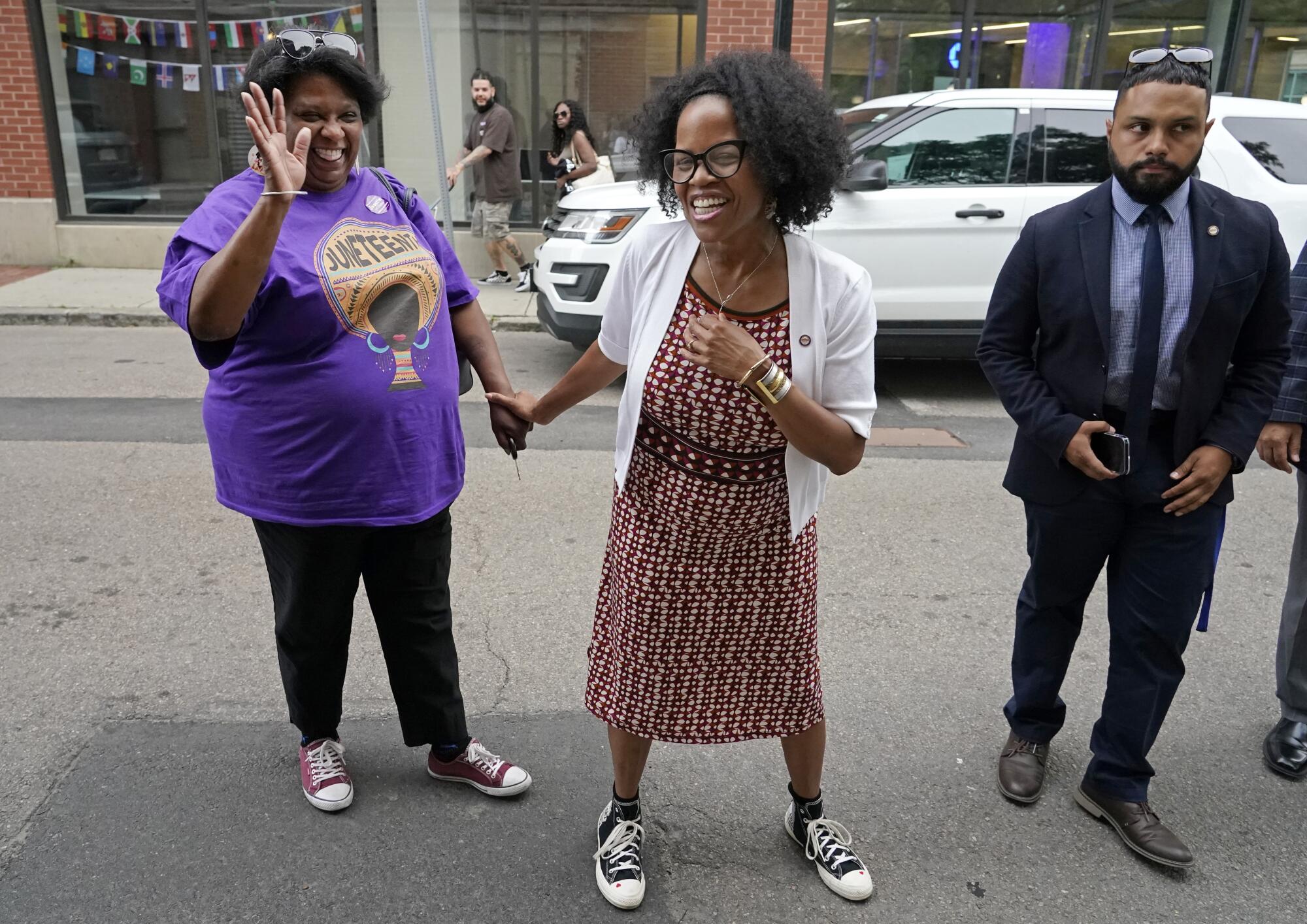 Boston's acting Mayor Kim Janey, center, meets with attendees in Boston's Nubian Square during a Juneteenth event.