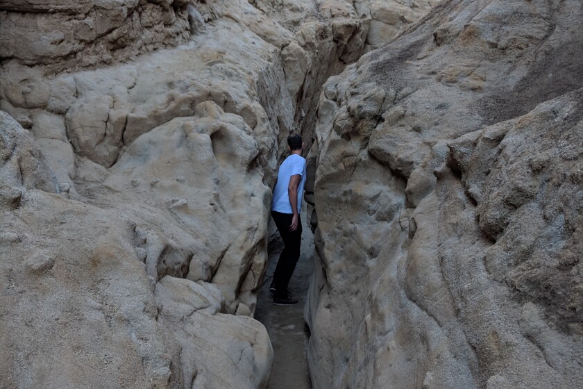 THE SLOT Length: 2.25-mile loop Elevation gain: 300 feet Trailhead: 2 miles north of CA-78 via Buttes Pass Rd Parking: Dirt lot, $10 Why have a little, when you can have a slot? No list of desert classics is complete without a trip through a slot canyon. Simply named The Slot, Anza-Borrego Desert State Park's narrow siltstone canyon is the epitomic experience to squeeze, duck and maneuver through the geological ravine, which houses creosote bush and cholla cactus. Negotiating around the 40-foot rock walls is half the fun (or claustrophobic for some) and is especially awesome when the trench-traversing trail winds under a natural bridge formed by a sedimentary slab. Created by years of flash floods, the tapered slot itself lasts under a mile, but you can steeply ascend to get views of the epic chasm, nearby West Butte Mountain, and the farther out Laguna Mountains framing the desert backdrop. Slot damn!