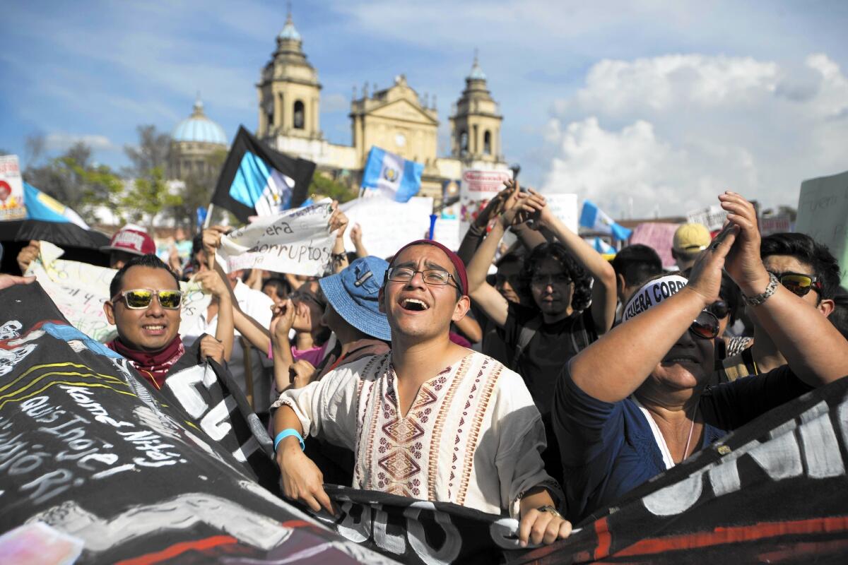 People chant slogans outside the National Palace during a protest demanding the resignation of Guatemalan President Otto Perez Molina in Guatemala City on May 30.