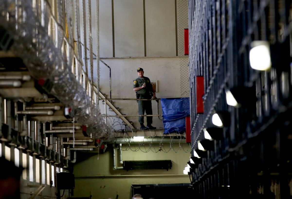 A guard stands watch over the condemned prisoners housed in East Block during a tour of Death Row at San Quentin.