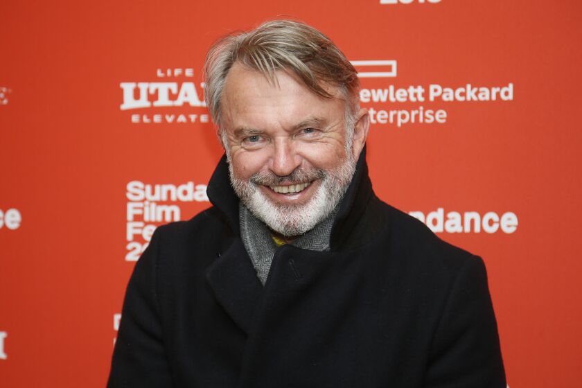 a film unfinished analysis A man with light hair and facial hair in a black coat