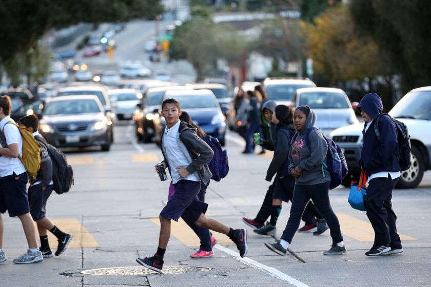 Students cross Fountain Avenue as they return to Thomas Starr King Middle School in East Hollywood on Wednesday morning.