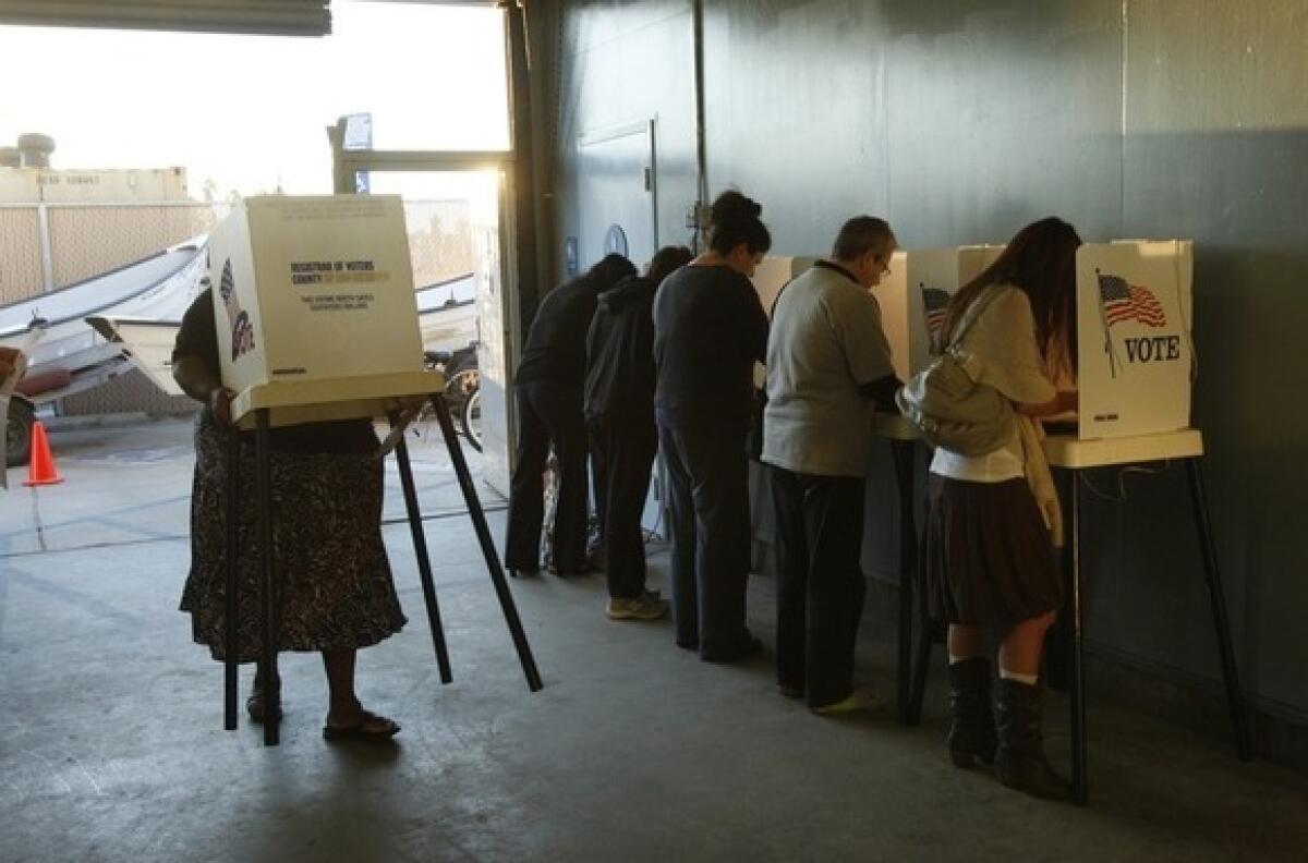 Precinct coordinator Lenise Newby carries an extra polling booth at a polling place inside the Venice Beach Life Guard Headquarters on Nov. 2, 2010.