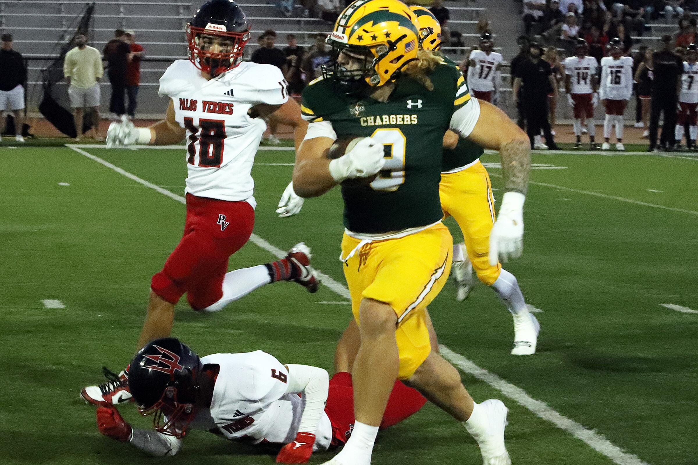 Edison's Julius Gillick (9) breaks a tackle and runs close to the goal Line during Edison High School's football team.