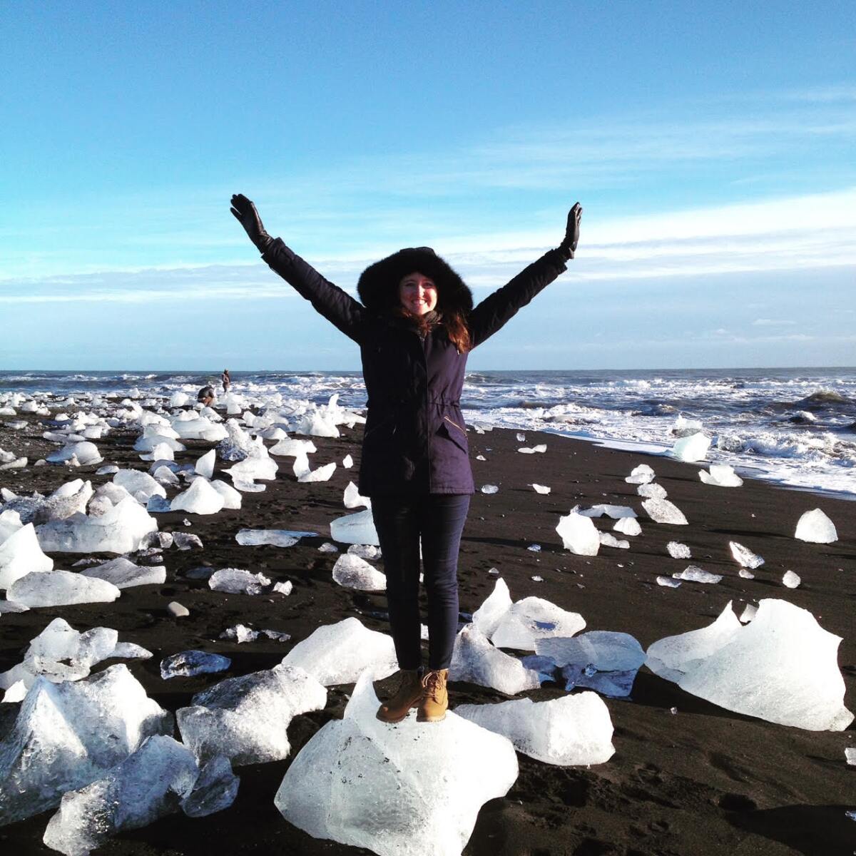 Author Charlotte McConaghy stands on floating ice in Iceland.