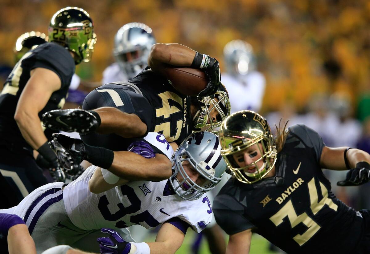 Baylor receiver Levi Norwood is upended by Kansas State linebacker Will Davis during the Big 12 Conference championship game on Saturday.