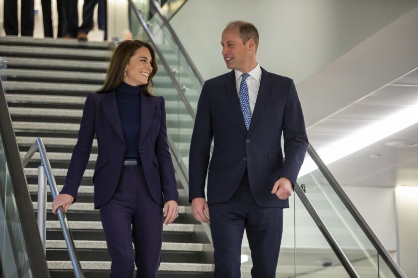 In this photo provided by the Massachusetts Governor's Press Office, Britain's Prince William, center, and Kate, Princess of Wales, left, arrive at Boston Logan International Airport on Wednesday, Nov. 30, 2022, in Boston. The Prince and Princess of Wales are making their first overseas trip since the death of Queen Elizabeth II in September. (Joshua Qualls/Massachusetts Governor's Press Office via AP)