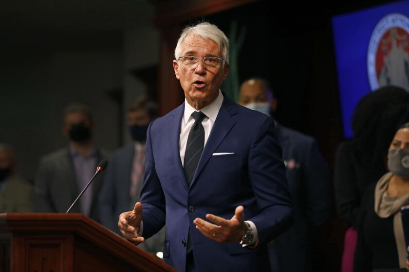 Los Angeles, California-Dec. 8, 2021-Los Angeles District Attorney George Gascon speaks during an end-of-year press conference to discuss his first year in office on Dec. 8, 2021. D.A. Gascon is flanked by a number of progressive D.A.'s from around the country including Boston D.A. Rachel Rollins. (Carolyn Cole / Los Angeles Times)