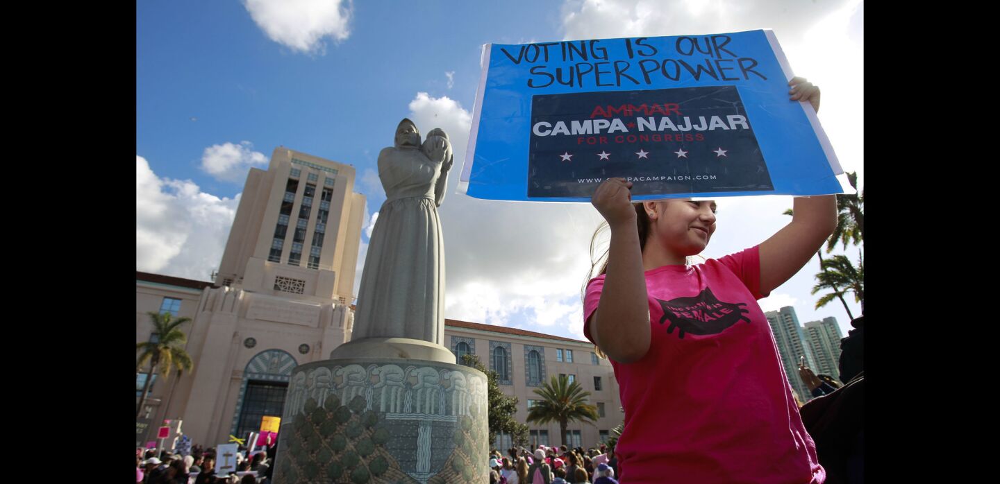 Charese Perry, 16, from Santee, holds a sign in favor of congressional candidate Ammar Campa-Najjar while in front of the County Administration Building.