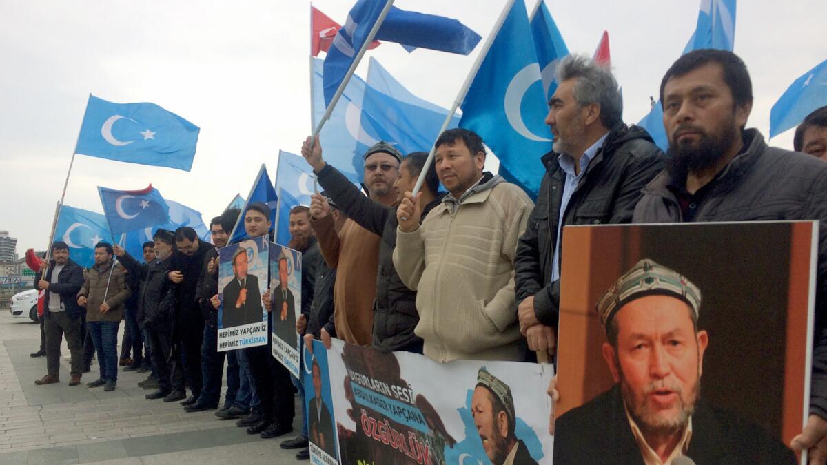 Uighurs protest outside an Istanbul courtroom in support of Abdulkadir Yapcan, who faces extradition to China.