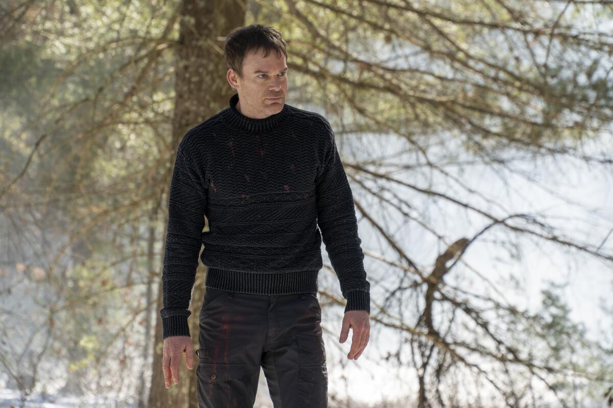 A man in dark clothing stands under a tree in "Dexter: New Blood."