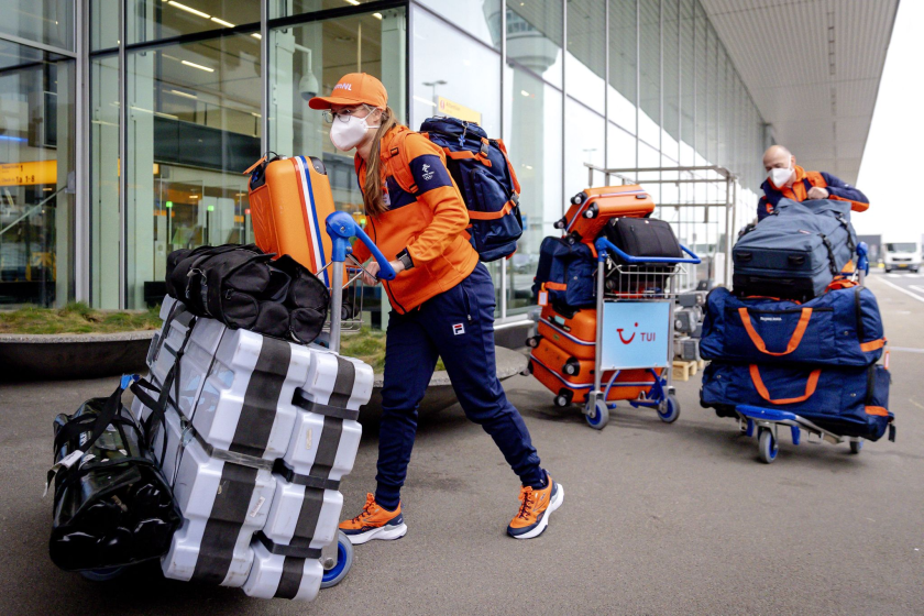 Dutch bobsledder Kimberley Bos, left, pushes her luggage at Amsterdam Airport Schiphol.