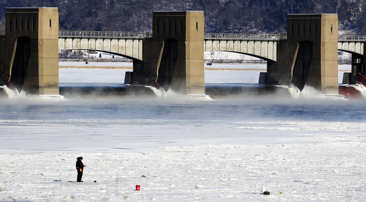 A person fishes near Lock and Dam No. 11 in Dubuque, Iowa, on New Year's Day.