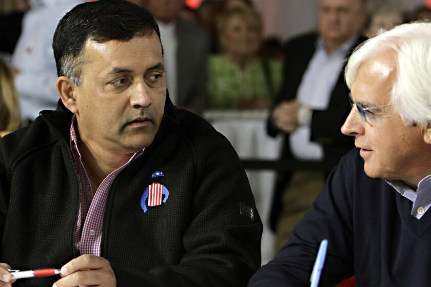 Dortmund owner Kaleem Shah, left, talks with trainer Bob Baffert before the start of the draw for the Kentucky Derby post position at Churchill Downs on Wednesday.