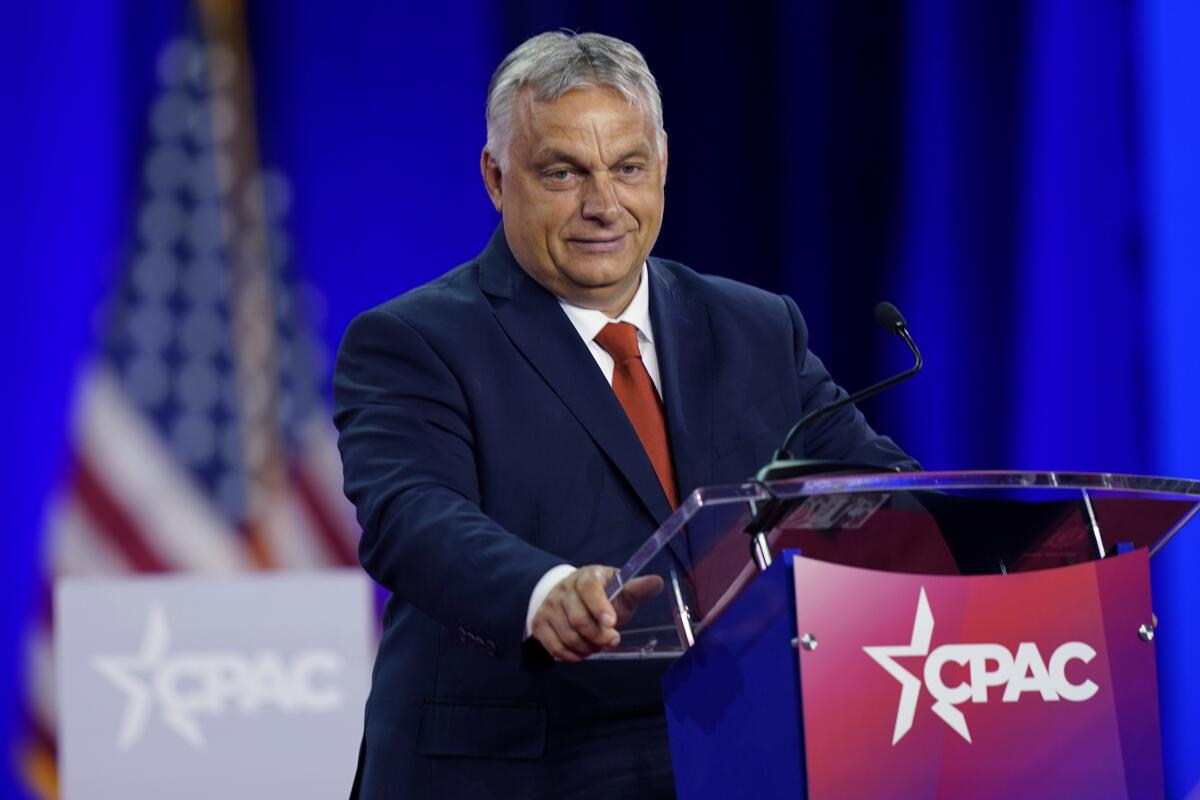 Viktor Orban stands at a lectern that says "CPAC" on it