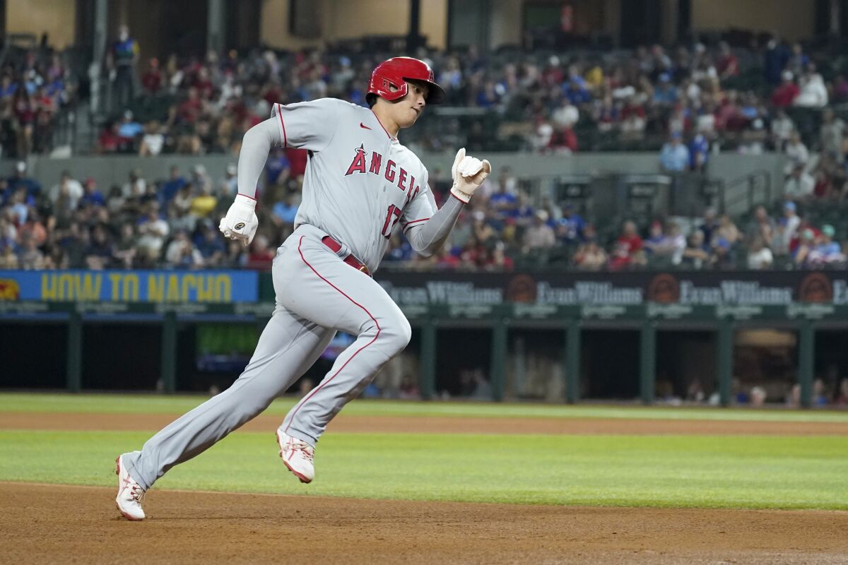 Los Angeles Angels' Shohei Ohtani sprints around third on his way home to score on a Phil Gosselin single in the fifth inning of a baseball game against the Texas Rangers in Arlington, Texas, Tuesday, Aug. 3, 2021. (AP Photo/Tony Gutierrez)