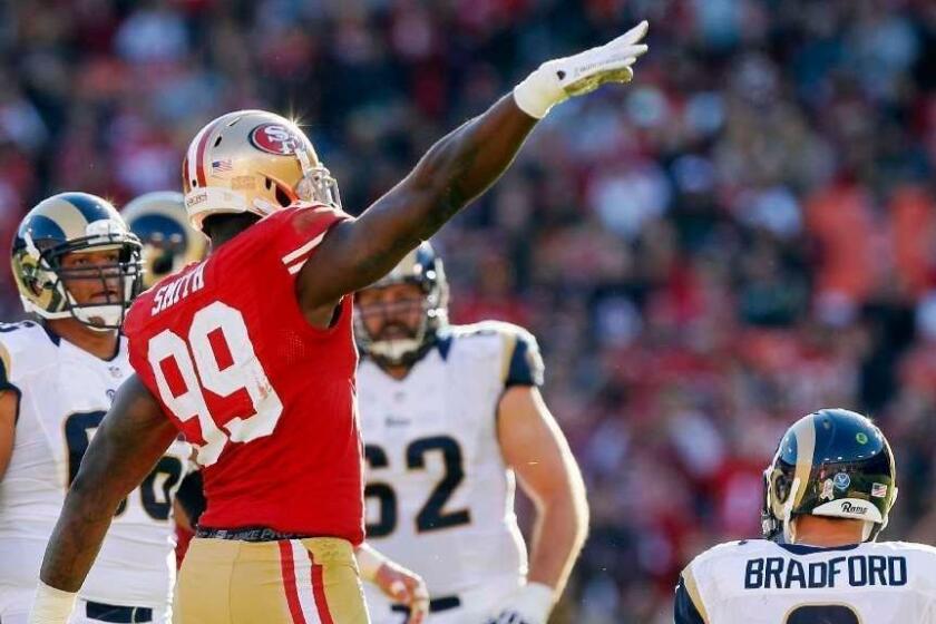 SAN FRANCISCO, CA - NOVEMBER 11: Linebacker Aldon Smith #99 of the San Francisco 49ers salutes the crowd on Veteran's Day after sacking quarterback Sam Bradford #8 of St. Louis Rams in the second quarter on November 11, 2012 at Candlestick Park in San Francisco, California. The teams tied 24-24 in overtime. (Photo by Brian Bahr/Getty Images) ORG XMIT: 154053365