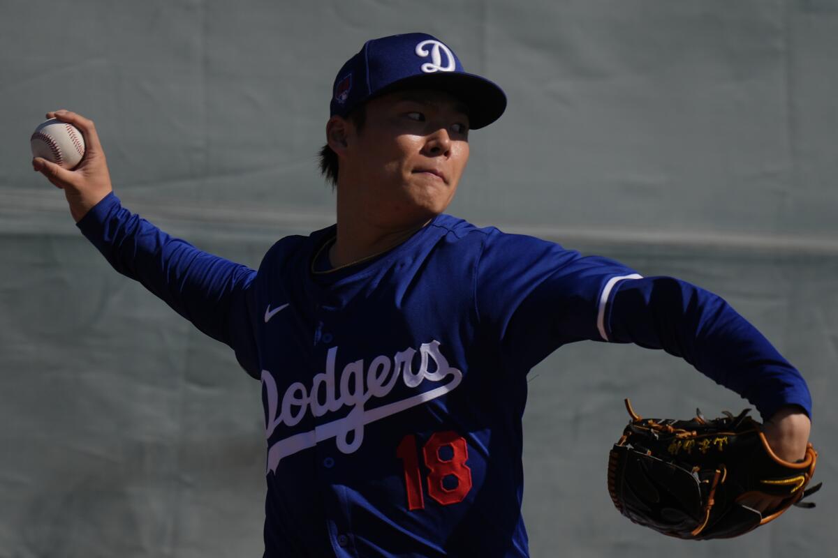 Dodgers pitcher Yoshinobu Yamamoto throws at Camelback Ranch on Friday.
