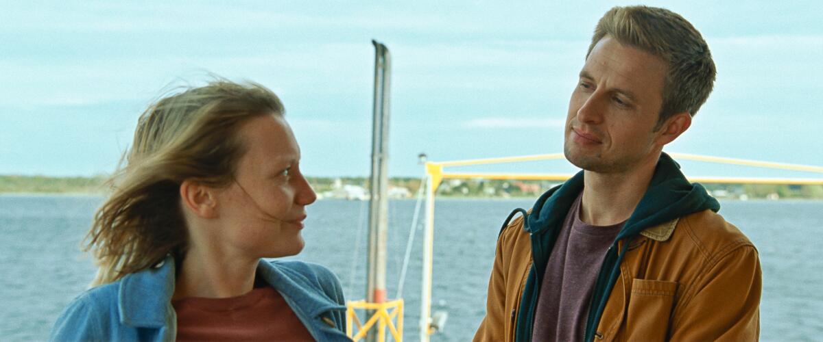 A couple look meaningfully at each other in the movie “Bergman Island.”