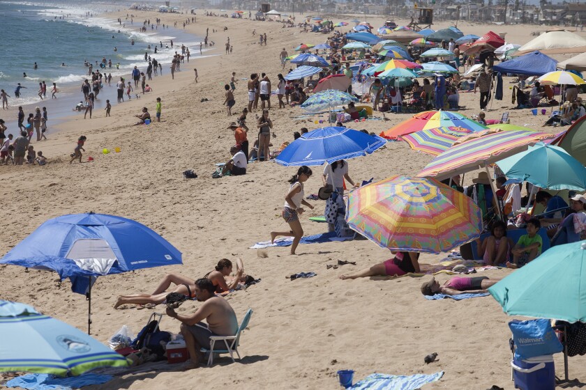 Looking north from Balboa Pier, hundreds crowd the coastline in Newport Beach in August.