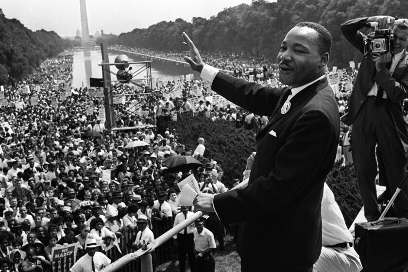 The civil rights leader Martin Luther KIng (C) waves to supporters 28 August 1963 on the Mall in Washington DC (Washington Monument in background) during the "March on Washington". King said the march was "the greatest demonstration of freedom in the history of the United States." Martin Luther King was assassinated on 04 April 1968 in Memphis, Tennessee. James Earl Ray confessed to shooting King and was sentenced to 99 years in prison. King's killing sent shock waves through American society at the time, and is still regarded as a landmark event in recent US history. AFP PHOTO (Photo credit should read -/AFP/Getty Images) ** TCN OUT ** ORG XMIT: BIO-MART