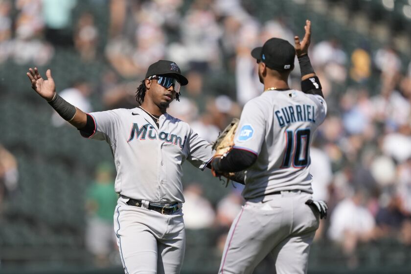 Miami Marlins' Jean Segura, left, and Yuli Gurriel celebrate the team's 5-1 win over the Chicago White Sox after a baseball game Saturday, June 10, 2023, in Chicago. (AP Photo/Charles Rex Arbogast)
