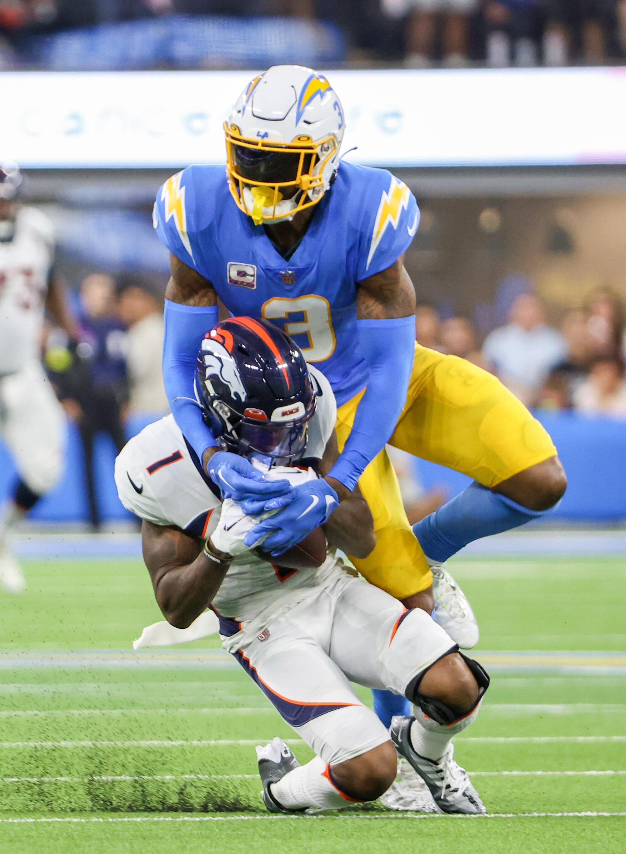 Denver Broncos wide receiver KJ Hamler hauls in a long pass over Chargers safety Derwin James Jr. in the first half.