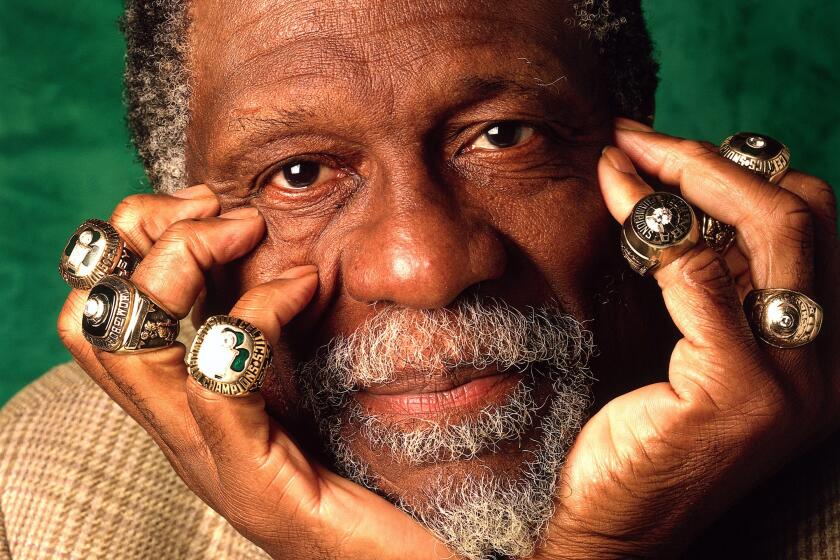 Bill Russell of the Boston Celtics poses for a photo with eleven of his Championship rings in 1996 in Boston, Massachusetts.
