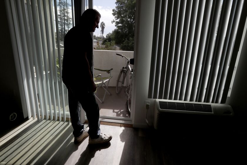LOS ANGELES, CALIF. - FEB. 13, 2018. Cliff Allen checks out his one-bedroom apartment in a Section 8 housing complex in the San Fernando Valley. Located on the sunny side of the building and across the steet from a public park, the apartment is a world apart from where Allen lived in Manchester Square, a condemned nighborhood near LAX that had become a magnet for homeless people before officials shut it down in January 2018. (Luis Sinco/Los Angeles Times)