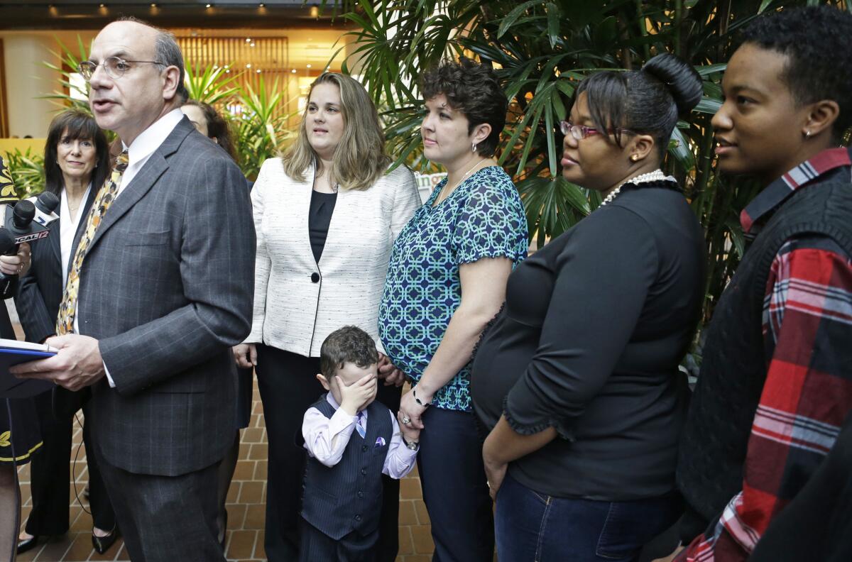 Attorney Al Gerhardstein, left, stands with several same-sex couples at an April 4 news conference in Cincinnati.