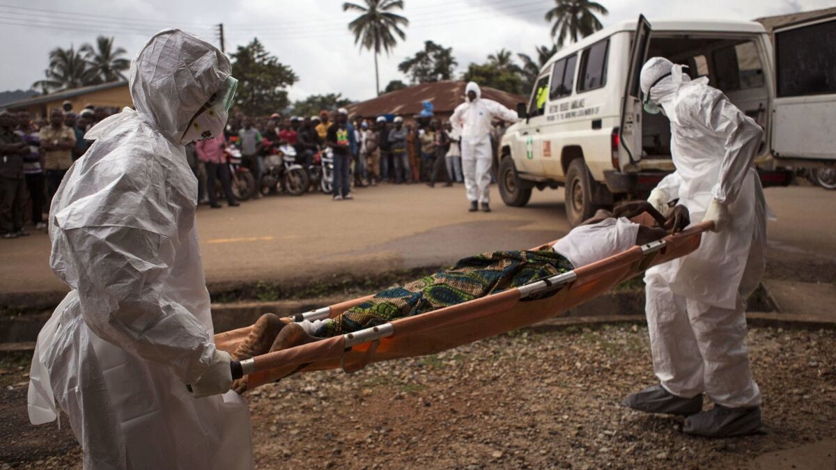 Healthcare workers in 2014 transport a suspected Ebola victim in Kenema, Sierra Leone.