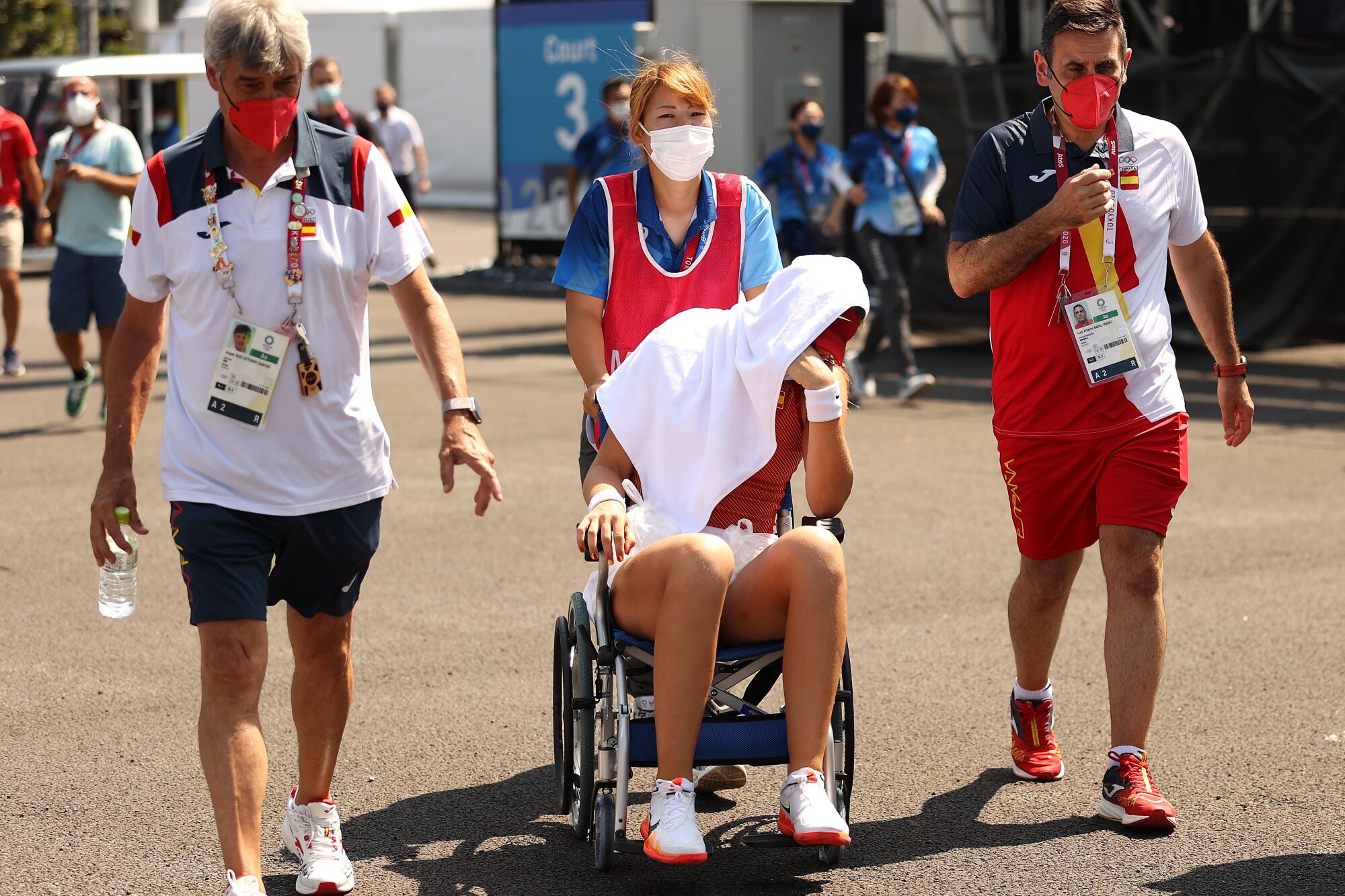 Paula Badosa of Spain is helped from the court in a wheelchair after retiring from her women's singles quarterfinal. 