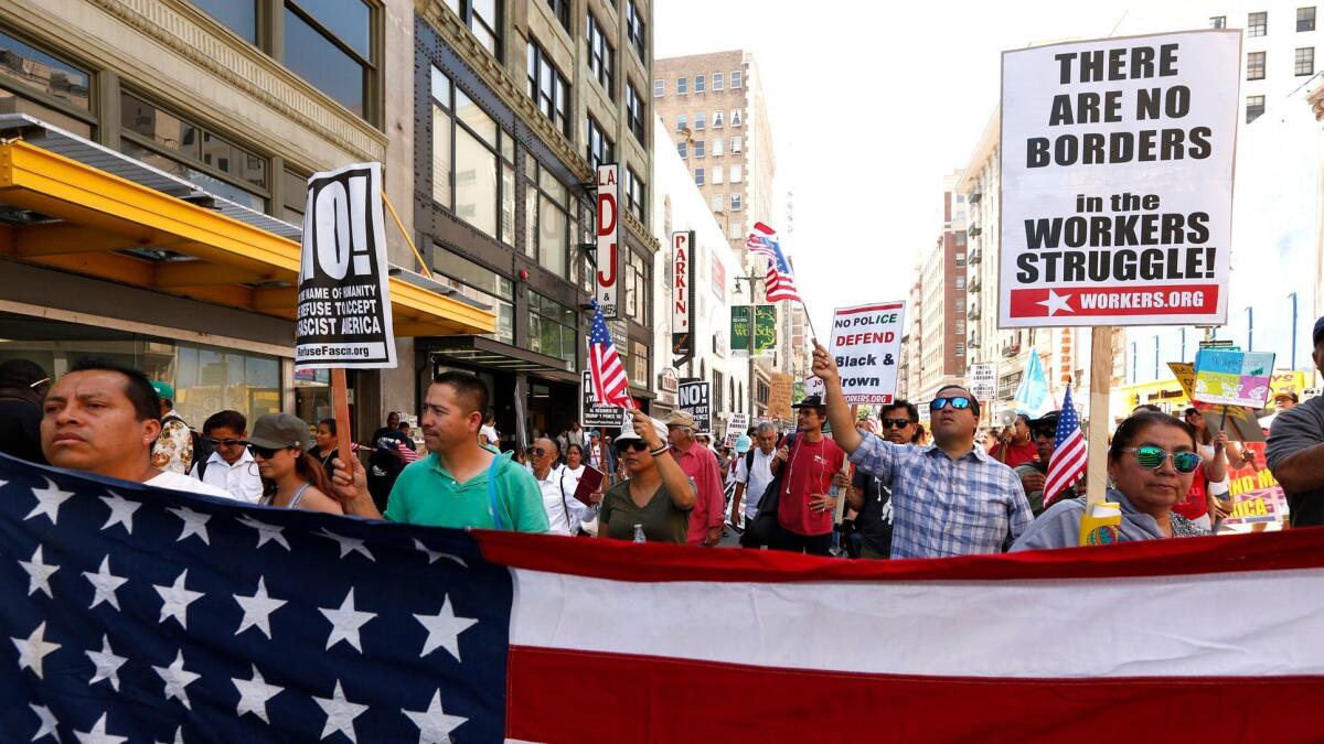May Day protesters in Los Angeles denounce Trump administration immigration policies. A federal appeals court on Monday heard arguments for and against the administration's revised travel ban.