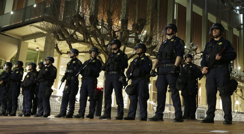 Berkeley police officers guard the campus building where conservative pundit Milo Yiannopoulos was to speak.