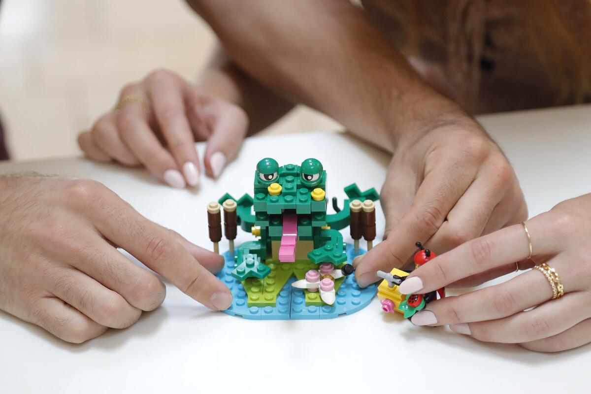 Bryan and Lauren Firks tidy up a frog scene build based on the one seen in the LEGO Masters show.
