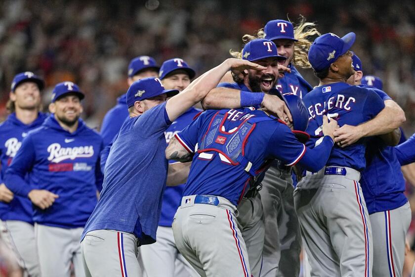 The Texas Rangers celebrate after Game 7 of the baseball AL Championship Series against the Houston Astros Monday, Oct. 23, 2023, in Houston. The Rangers won 11-4 to win the series 4-3. (AP Photo/David J. Phillip)