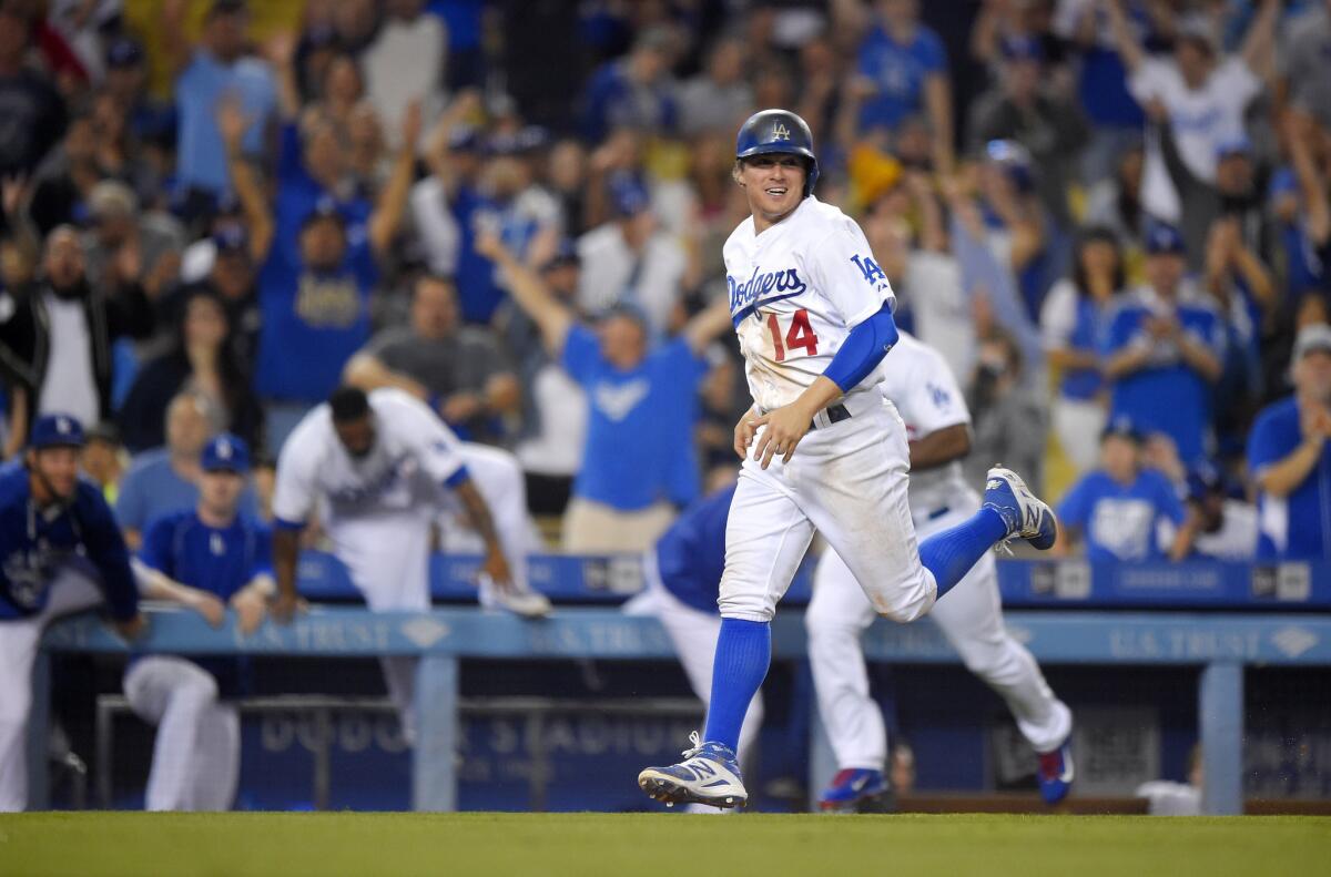 Dodgers infielder Enrique Hernandez scores the game-winning run after Texas reliever Keone Kela committed a balk during the nine inning. The Dodgers beat the Rangers, 1-0.