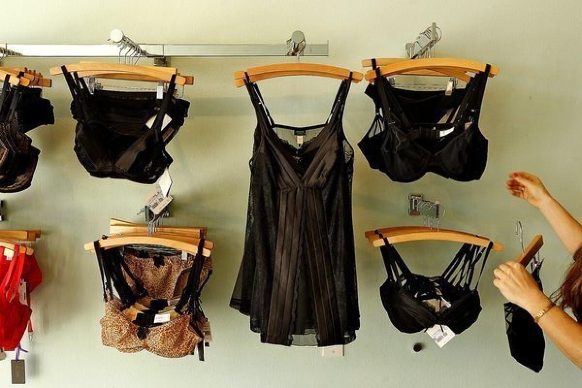 Owner Jen Abercrombie straightens up racks at her lingerie shop, Panty Raid, in Los Feliz.