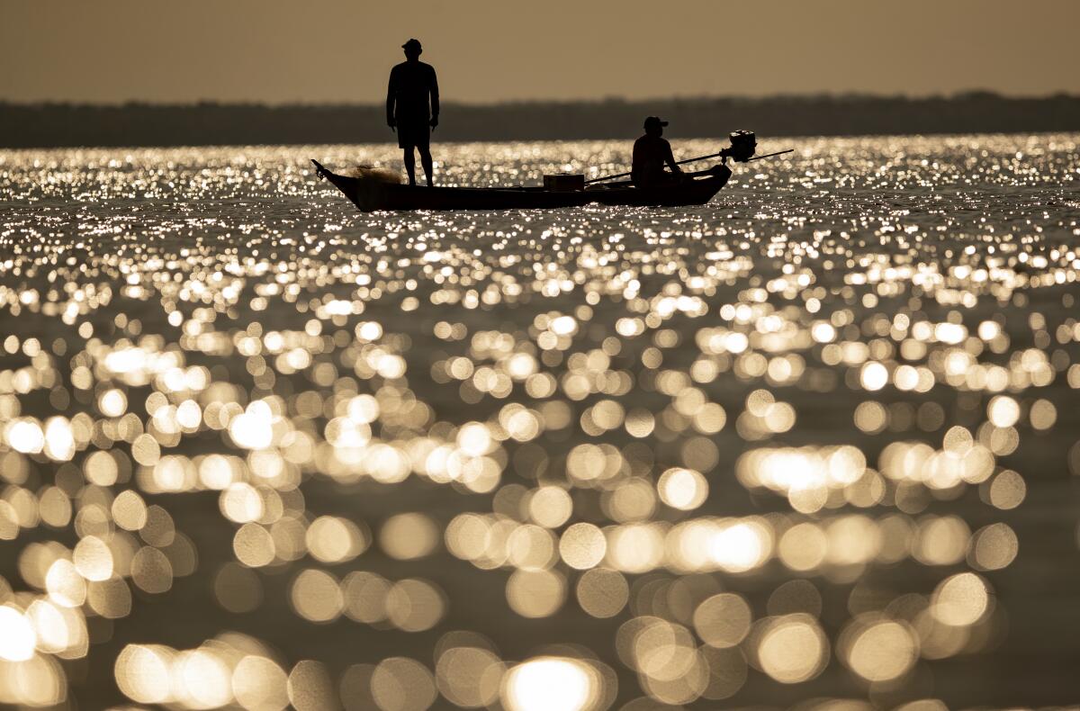 Fishermen ply their trade in the Tapajos river in Alter do Chao, Brazil, in late August. 