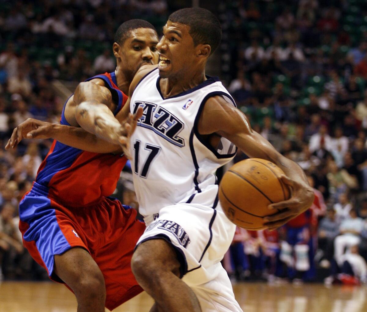 Utah Jazz guard Ronnie Price, right, drives by Los Angeles Clippers guard Jason Hart back in 2008.
