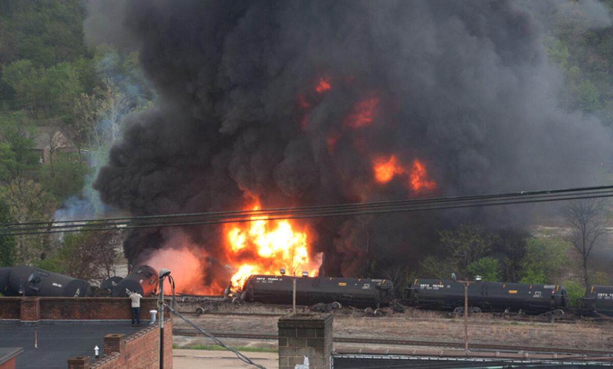 This image made available by the City of Lynchburg shows several CSX tanker cars carrying crude oil in flames after derailing in downtown Lynchburg, Va.