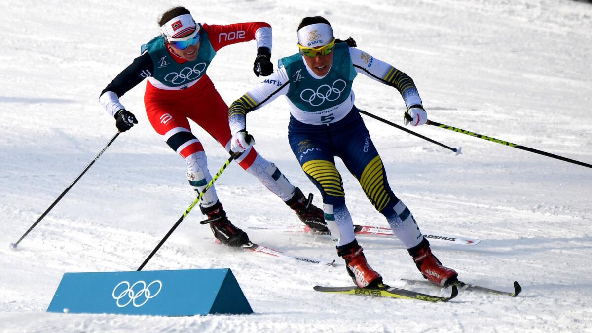 Sweden's Charlotte Kalla and Norway's Heidi Weng compete in the 15-kilometer cross-country skiathlon on Saturday.