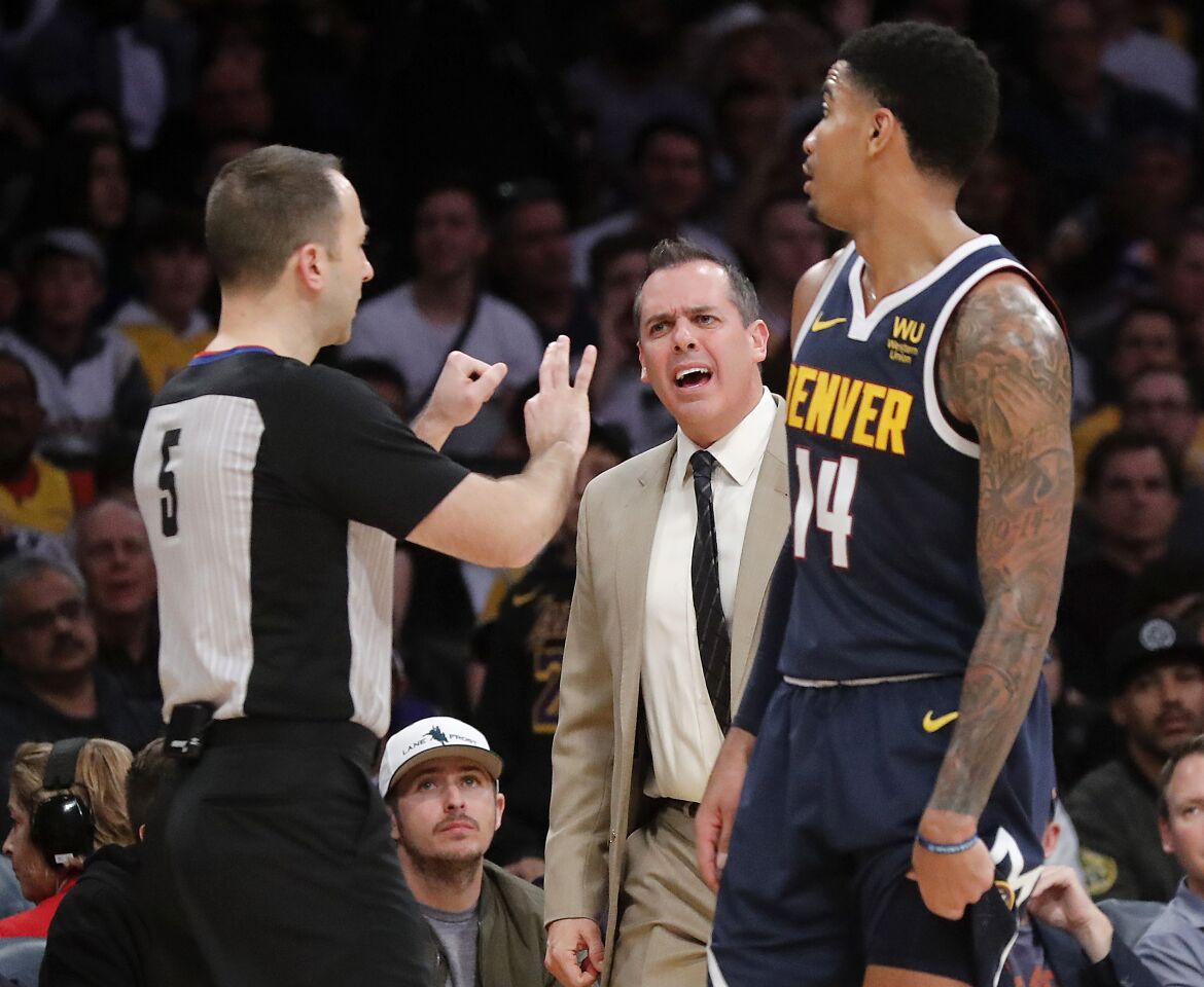 Lakers coach Frank Vogel, center, is upset with an official's call during the fourth quarter.