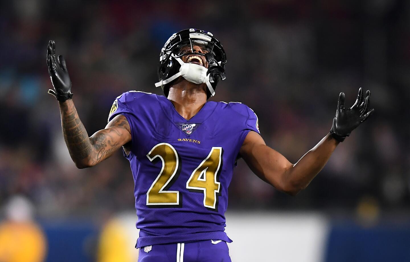 Ravens cornerback Marcus Peters laughs in fornt of the Rams' bench late in the fourth quarter of a game Nov. 25 at the Coliseum.