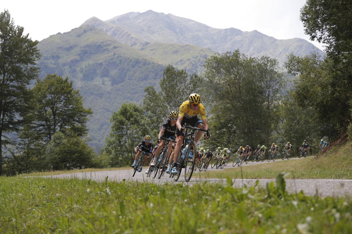 Chris Froome of Britain, wearing the overall leader's yellow jersey, speeds downhill with the pack during the twelfth stage of the Tour de France on Thursday.