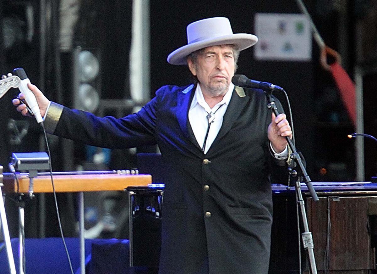 Bob Dylan performing on stage at the Les Vieilles Charrues Festival in Carhaix, France in 2013.