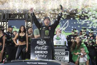 Tyler Reddick, center, celebrates after winning a NASCAR Cup Series auto race.