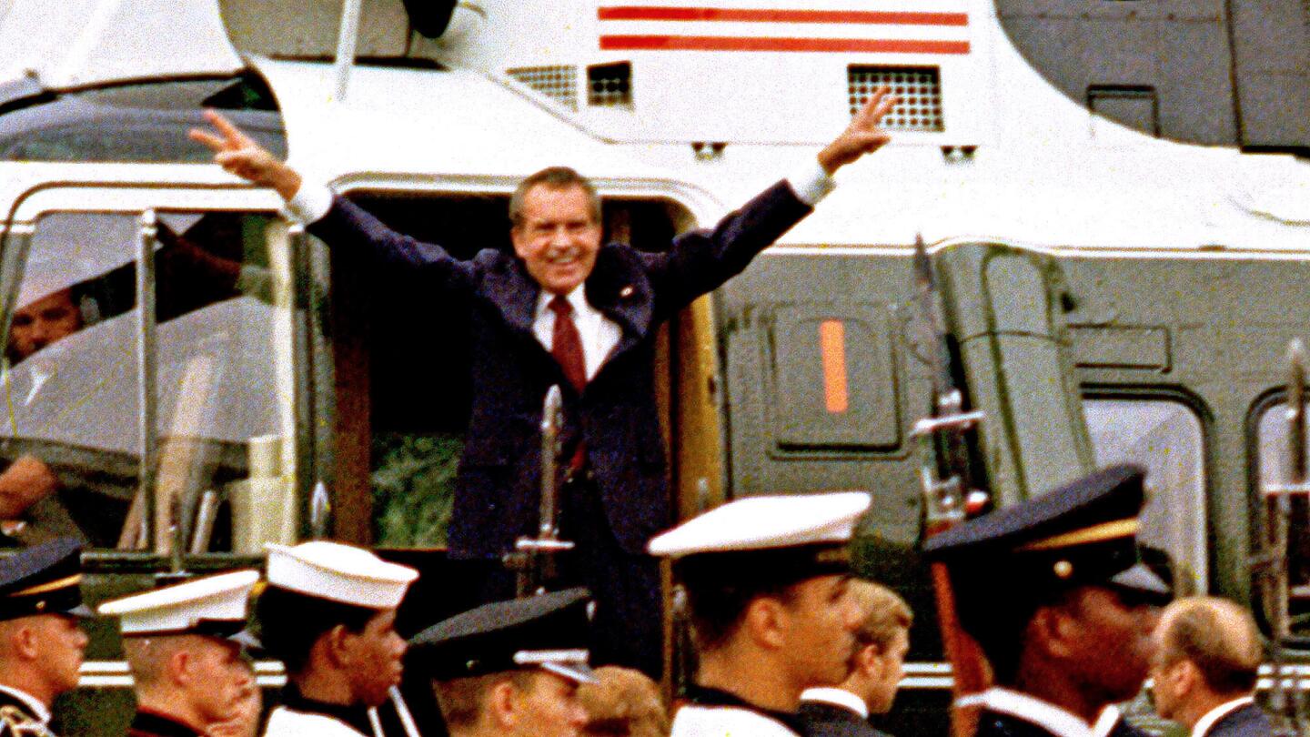 Shortly after giving up power, President Nixon salutes his staff before boarding a helicopter and leaving the White House on Aug. 9, 1974.