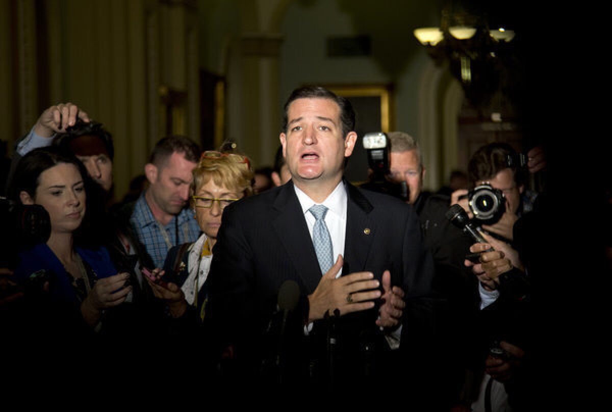 Sen. Ted Cruz, R-Texas, talks to reporters on Capitol Hill in Washington after House leaders reached a last-minute agreement to avert a threatened Treasury default and reopen the government after a partial, 16-day shutdown. Cruz made a name for himself by leading the tea party charge toward shutdown.